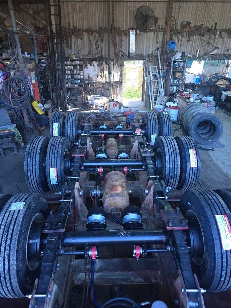 A Truck Chassis with Multiple Axles and Suspension Components Inside a Workshop — Banana Coast Heavy Diesel in Yamba, NSW