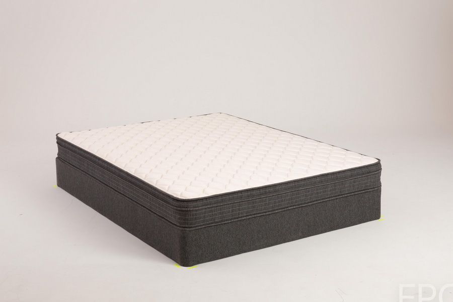 Mattress on a dark gray foundation; white quilted top with dark edging.