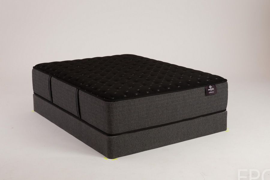 Black mattress on a matching dark gray base, lit against a white backdrop.