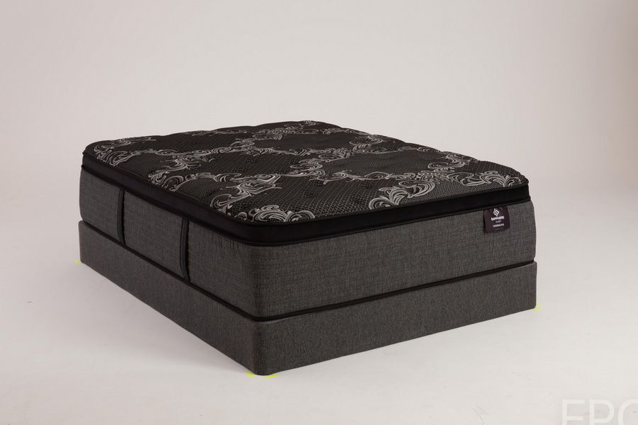 Dark gray mattress with a patterned black top on a matching base.