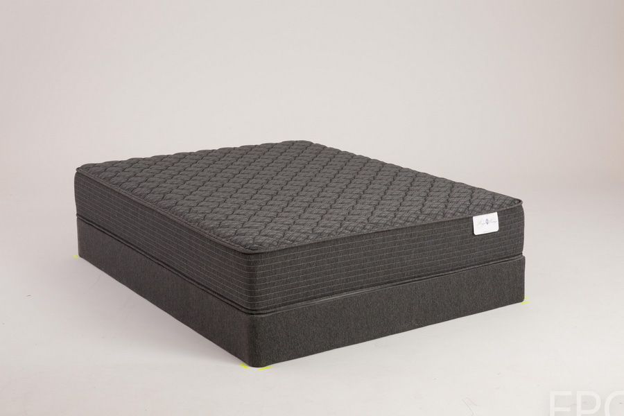 Black mattress on a matching base in a studio setting.