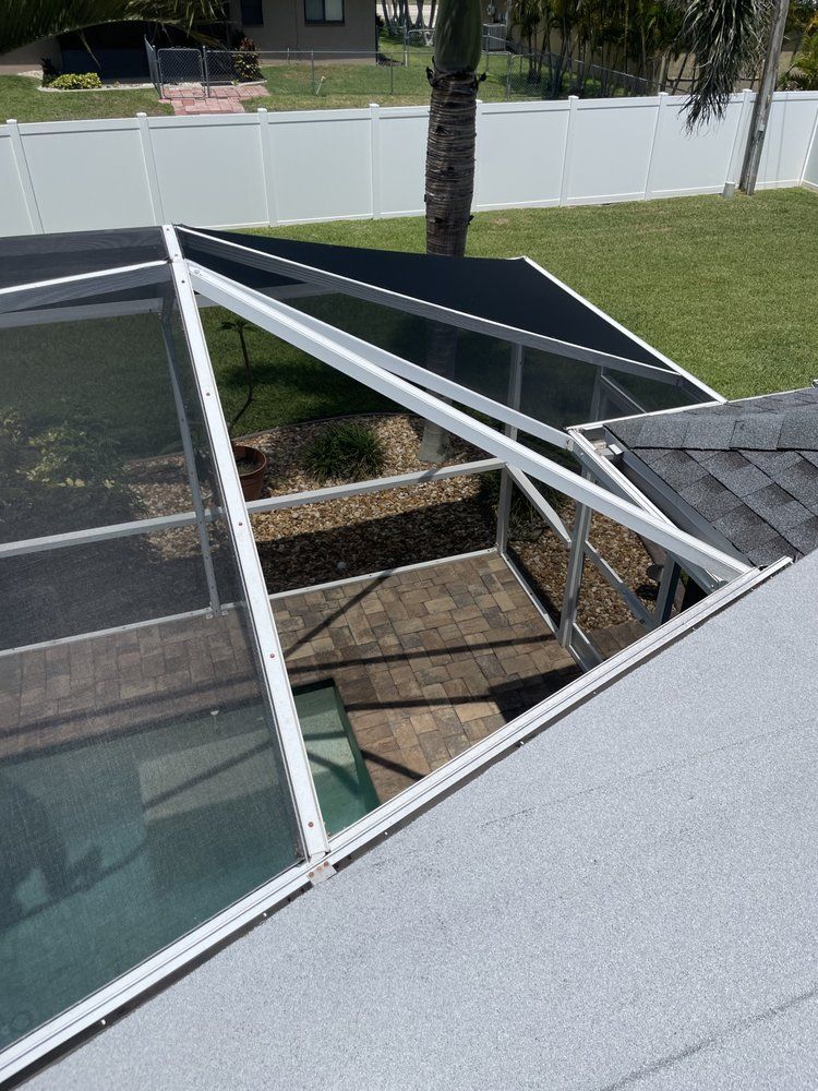 A screened in pool area with a view of a lake