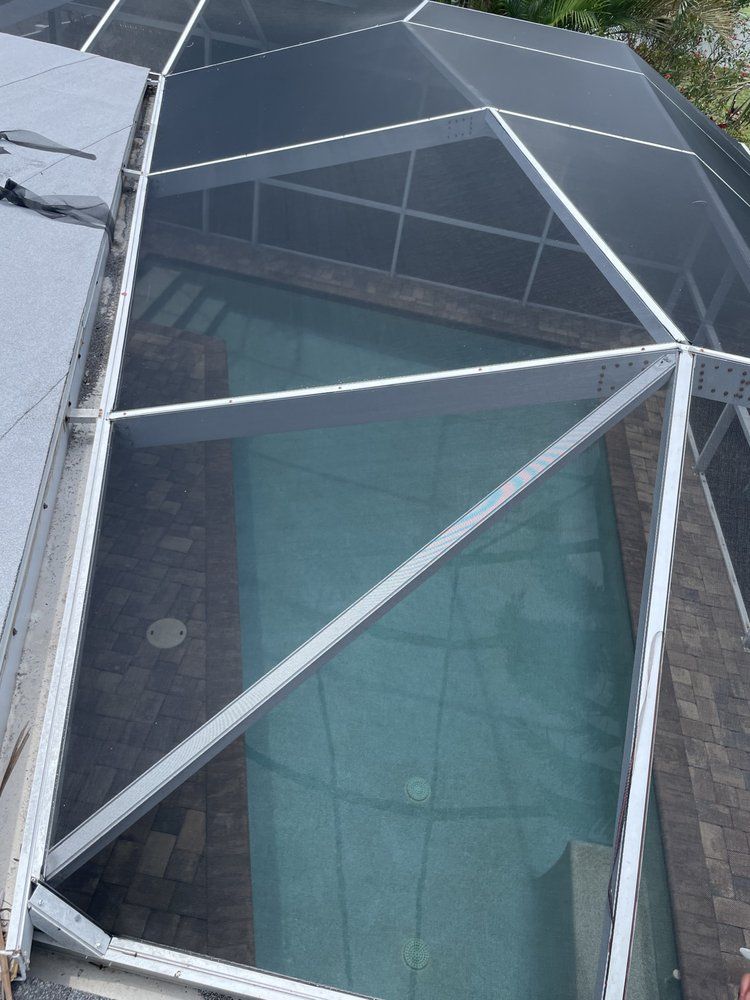 There is a large swimming pool in the backyard of a house.