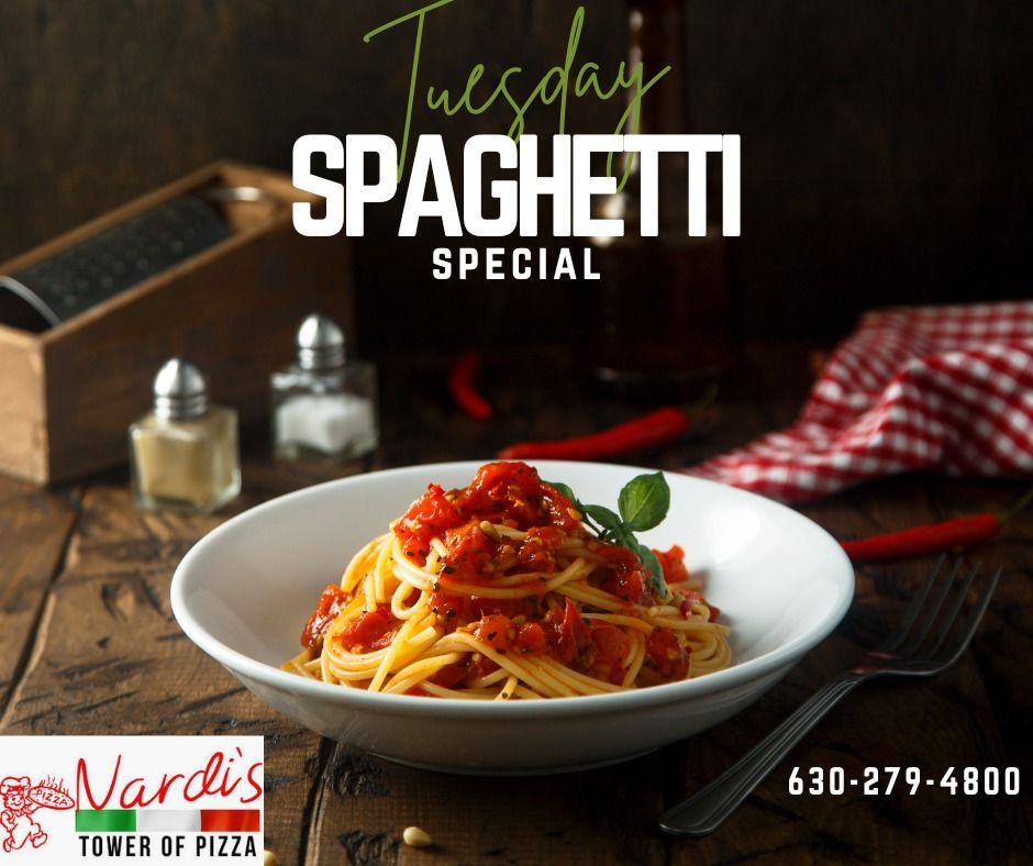 A white bowl of spaghetti with tomato sauce on a wooden table