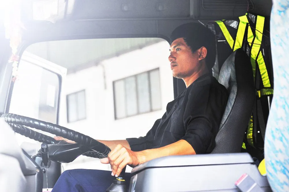 A Man is Sitting in the Driver 's Seat of a Truck — Truck Training and Assessments In Umina Beach, NSW