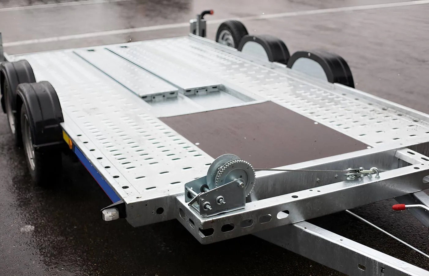 A Car Trailer is Parked in a Parking Lot — Truck Training and Assessments In Umina Beach, NSW