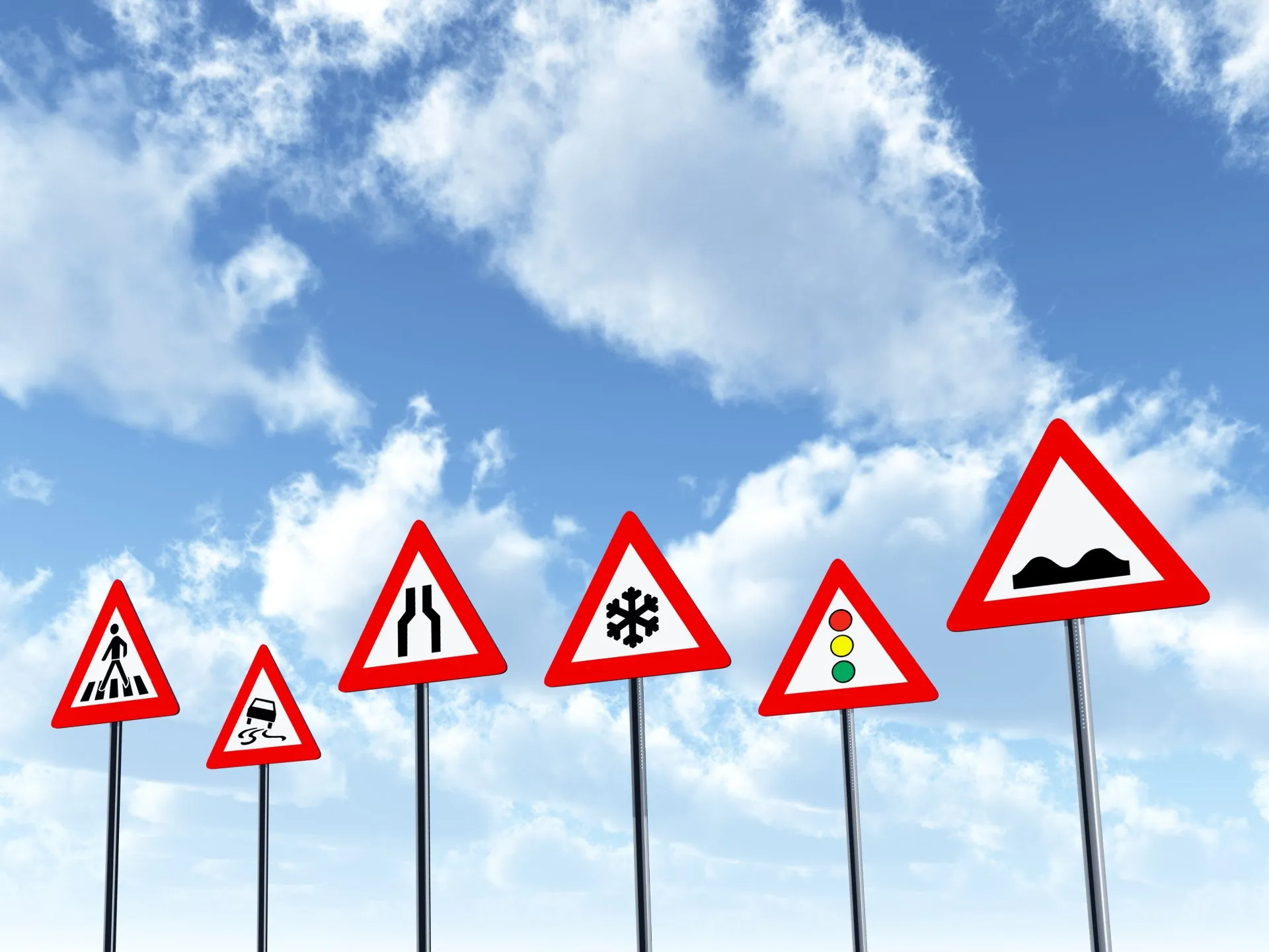 A Row of Road Signs Against a Blue Sky With Clouds — Truck Training and Assessments In Umina Beach, NSW