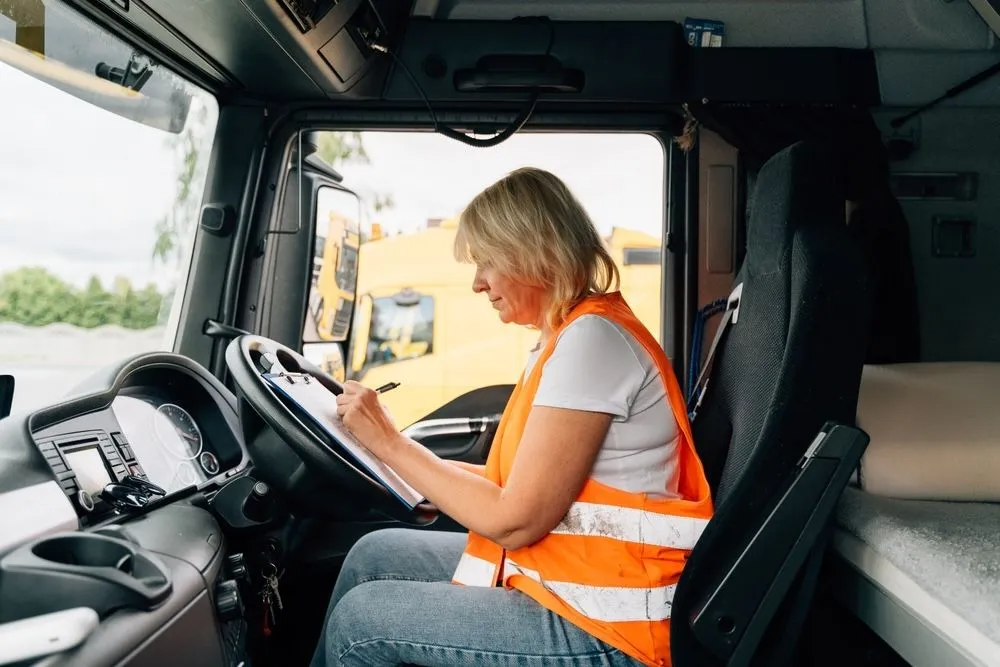 A Woman is Sitting in the Driver's Seat — Truck Training and Assessments In Umina Beach, NSW