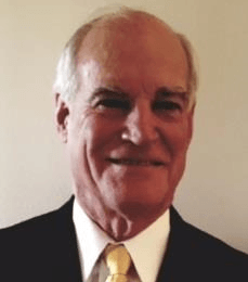 Smiling older man wearing a suit and tie.