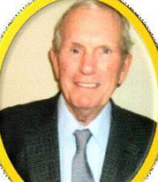 Smiling older man in a suit and tie, framed in yellow, facing forward.