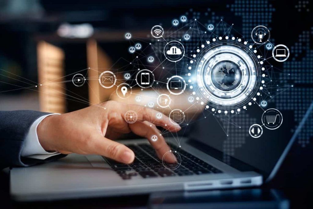 A close up of a person 's hand typing on a laptop computer.