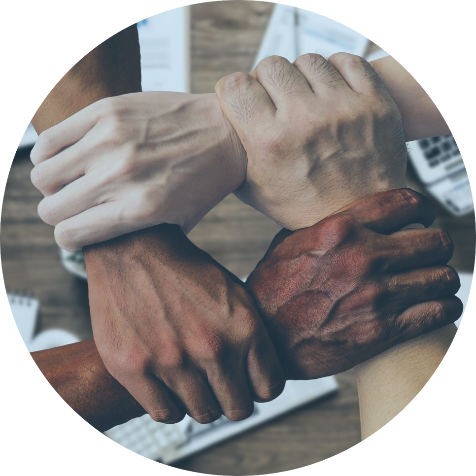 A group of people putting their hands together in a circle