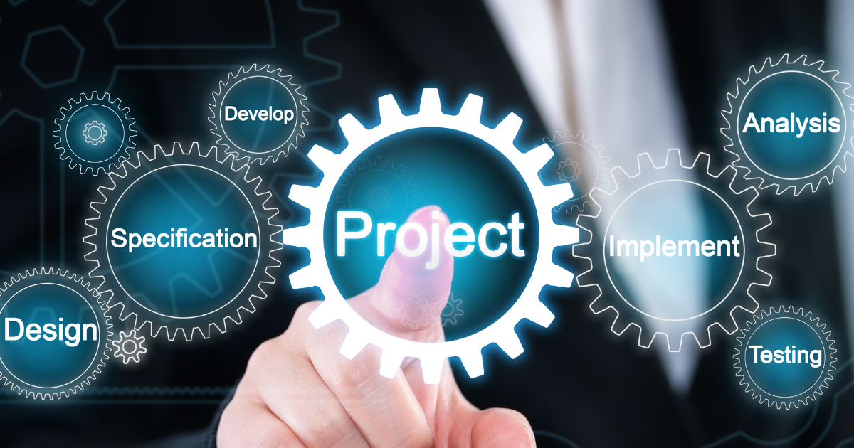 A person is pointing at a gear that says project