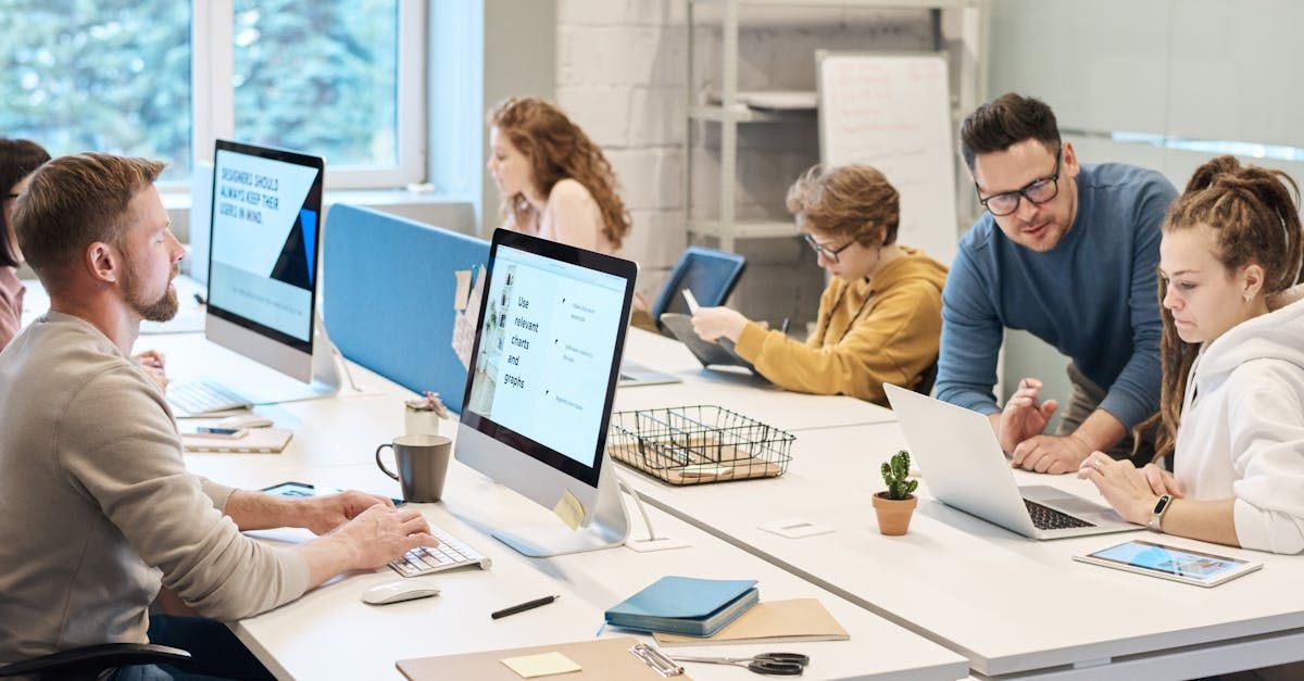 A group of people are working on computers in an office.