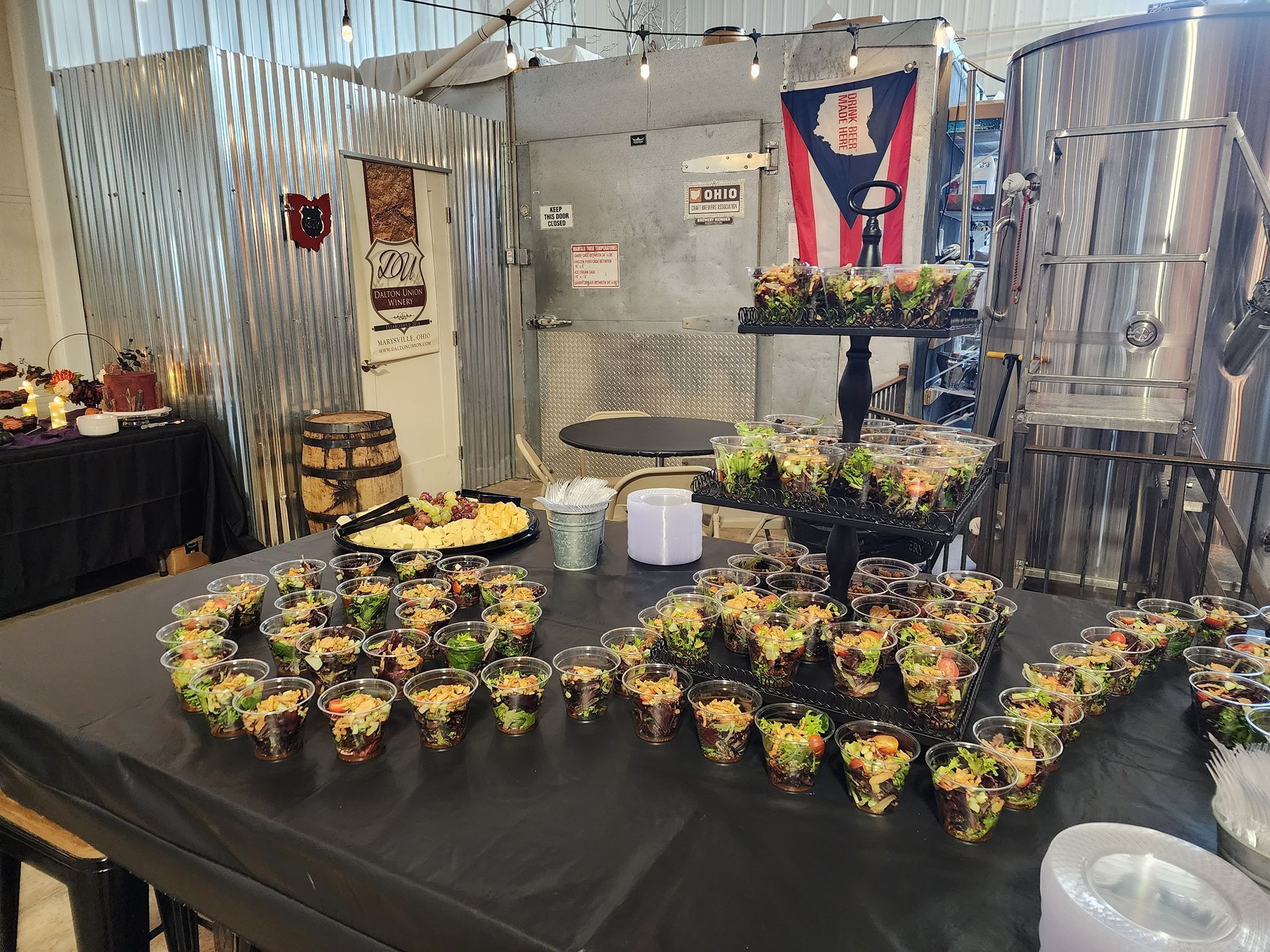 Table filled with potted plants and flowers at an indoor market display