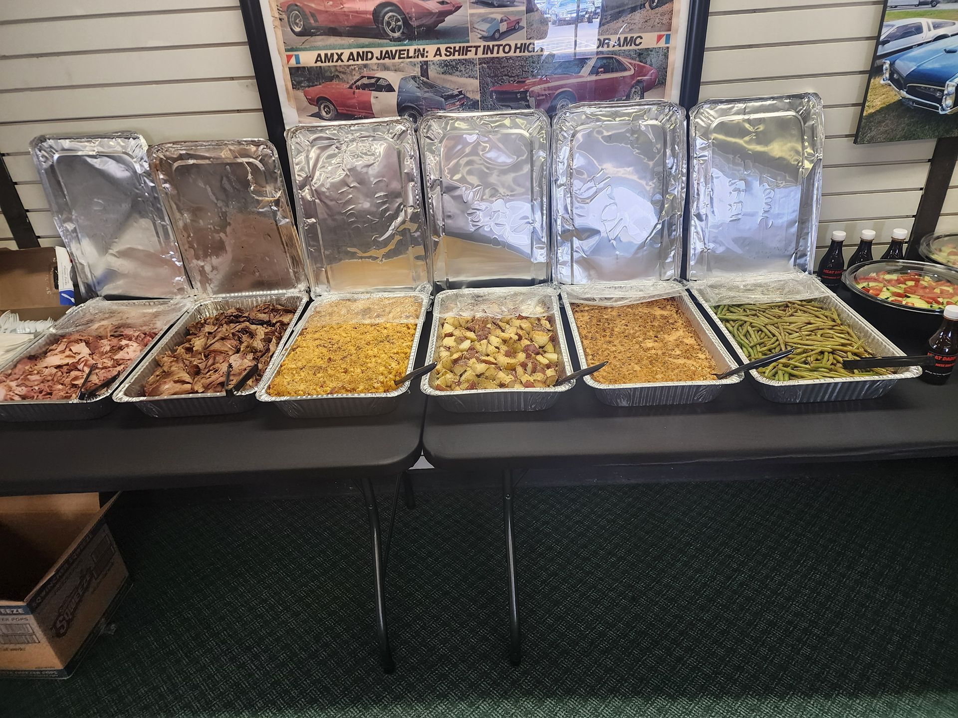 Buffet condiment bar with multiple trays of food in a restaurant setting