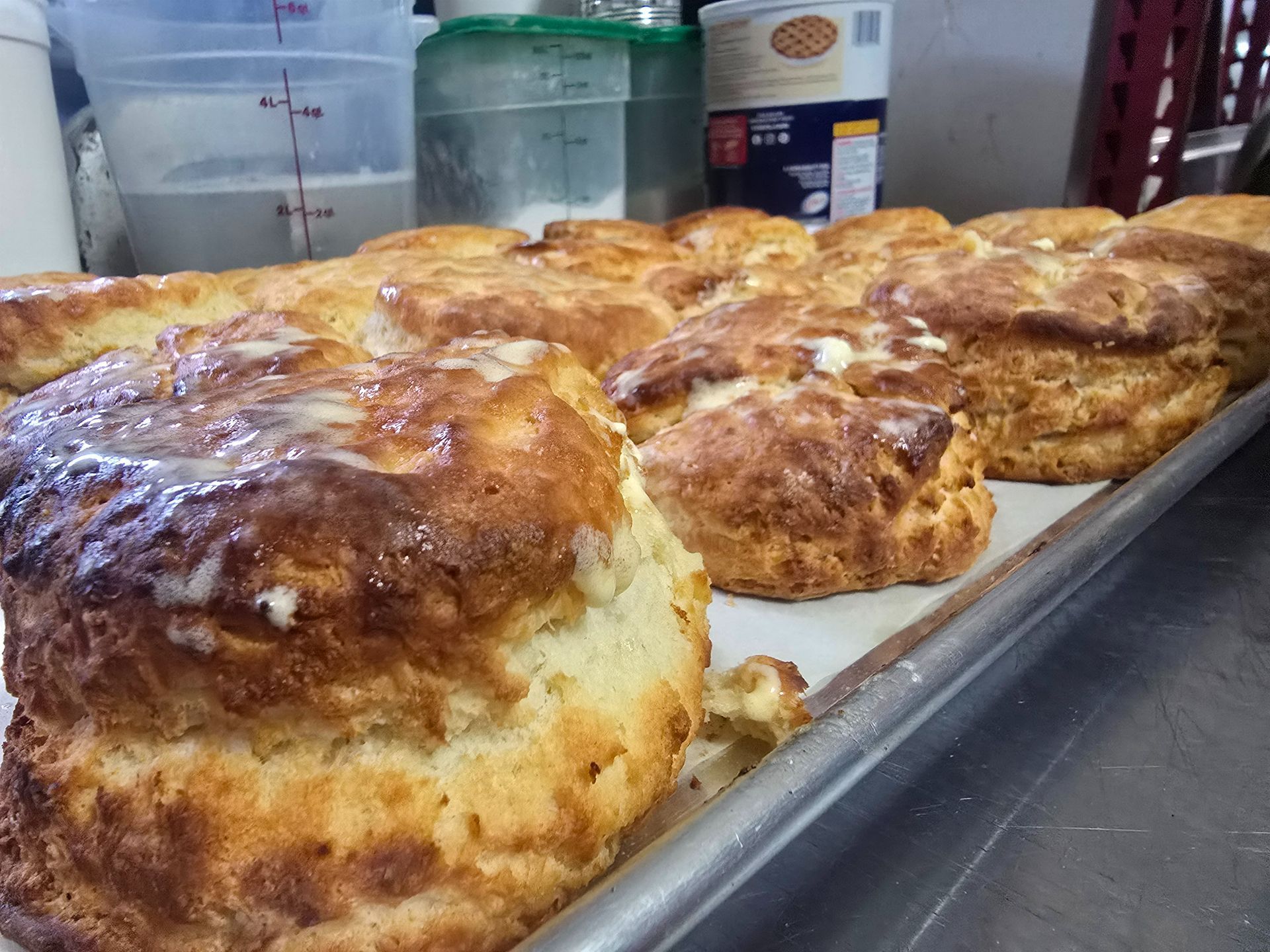 Tray of golden-brown baked goods on a counter in a kitchen setting