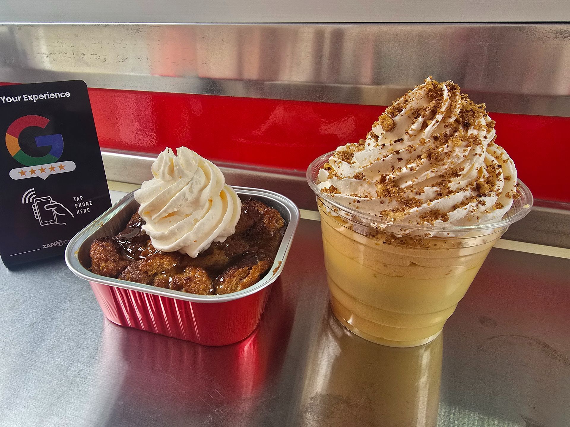 Two dessert cups on a table: a white-frosted chocolate dessert and a whipped-cream caramel drink.