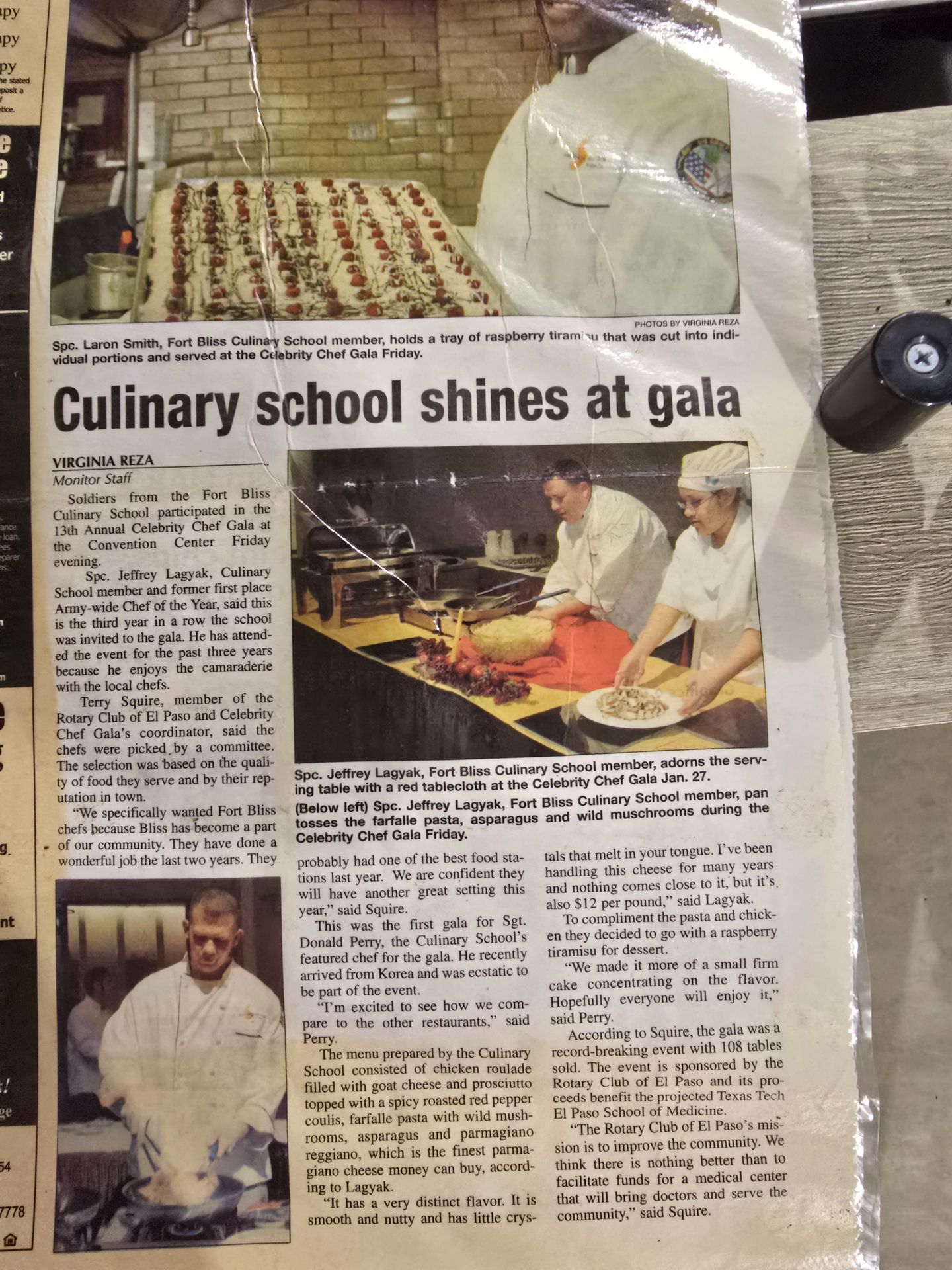 Newspaper clipping showing a culinary school gala with chefs and plated dishes on a table