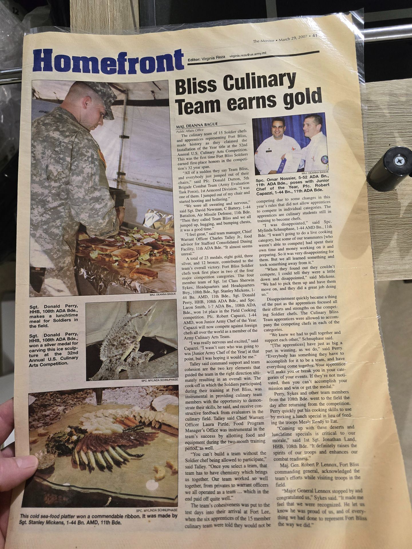 Newspaper clipping about Bliss Culinary Team earning gold, with photos of a chef and food display