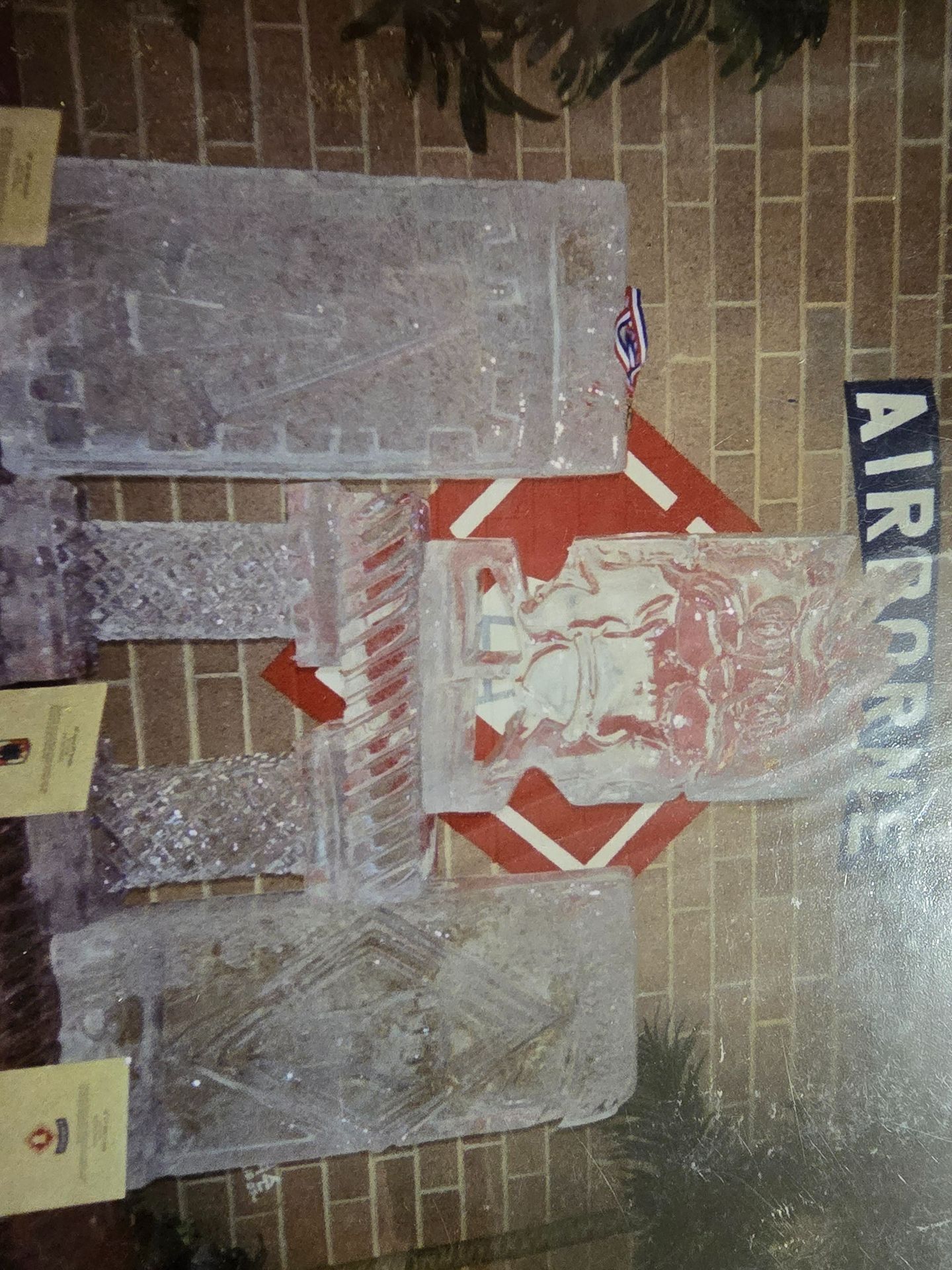 Clear bubble-wrapped packages on a brick wall, with a red stop-sign shape and “AIR…” lettering nearby.