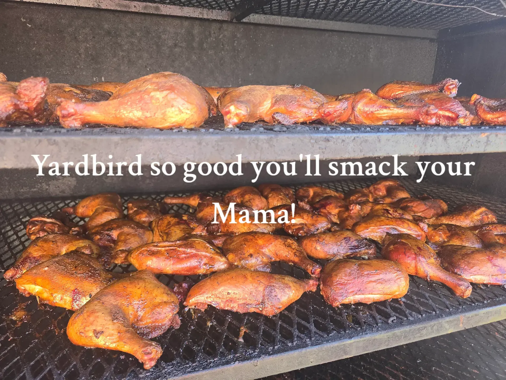 Smoked meat piled on a grill with text overlay reading, “Yardbird so good you'll smack your Mama.”