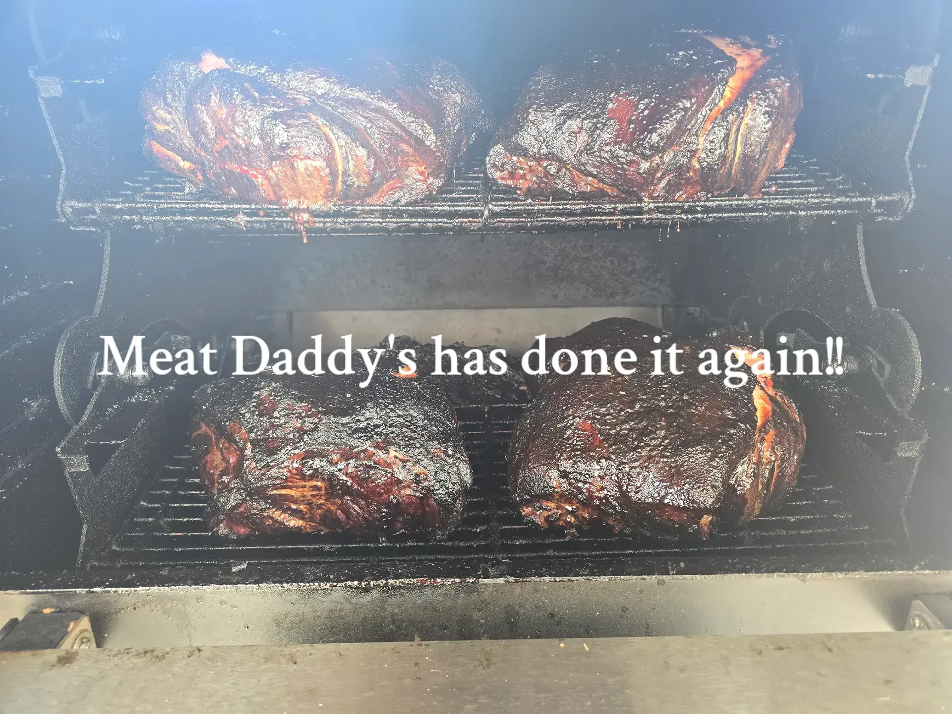 Smoked meats in a grill with text: “Meat Daddy’s has done it again!”