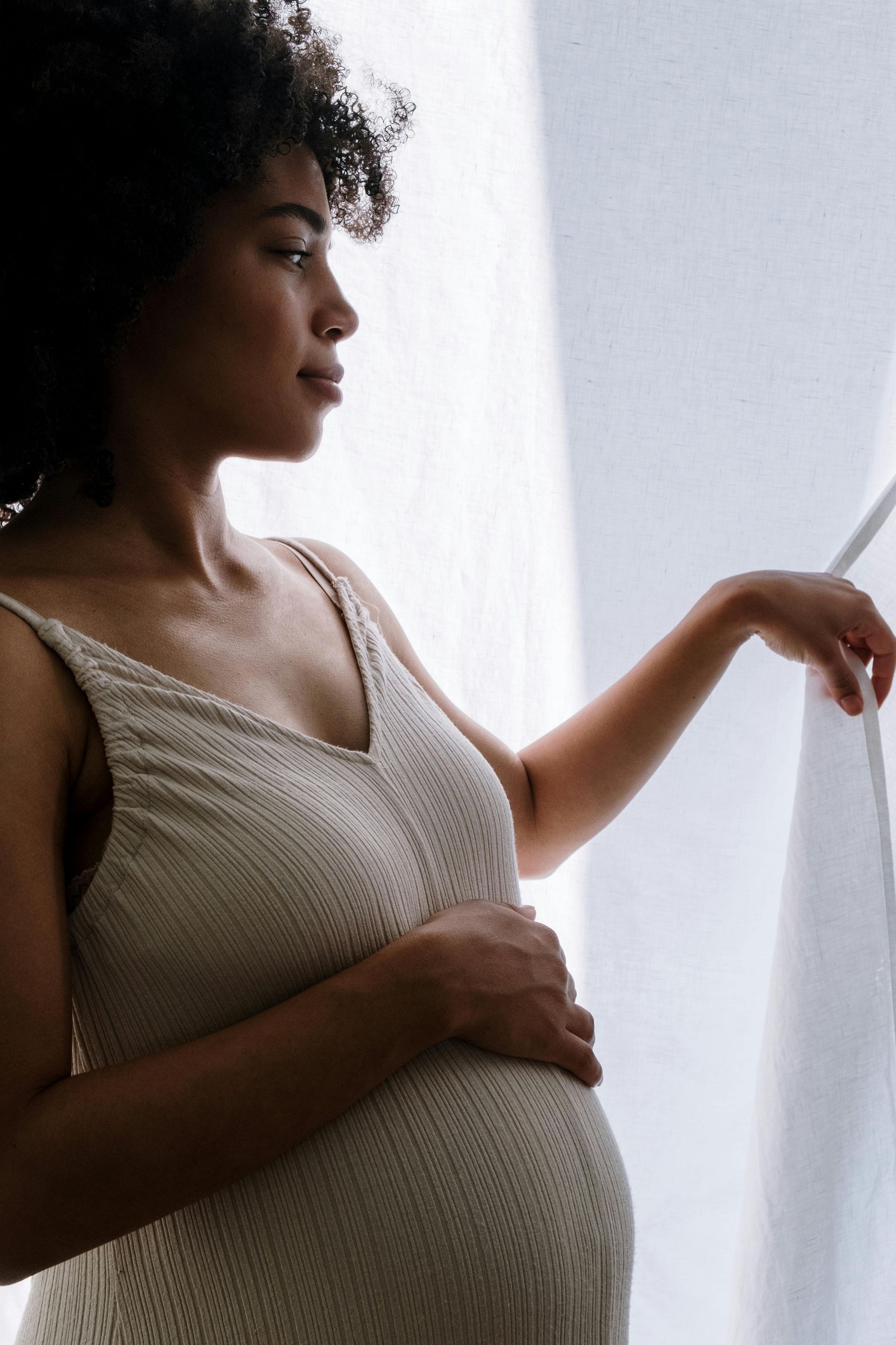 Pregnant woman opening back curtain