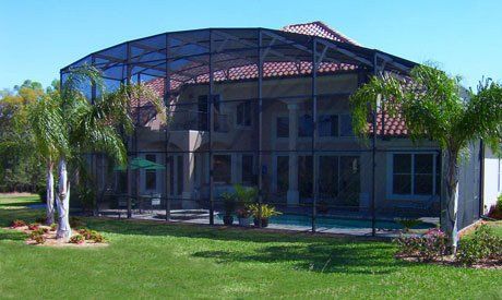 Large house with small trees and pool enclosure — Leesburg, FL — Aluminum Contractors Inc