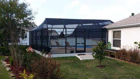 White house with nice pool enclosure — Leesburg, FL — Aluminum Contractors Inc