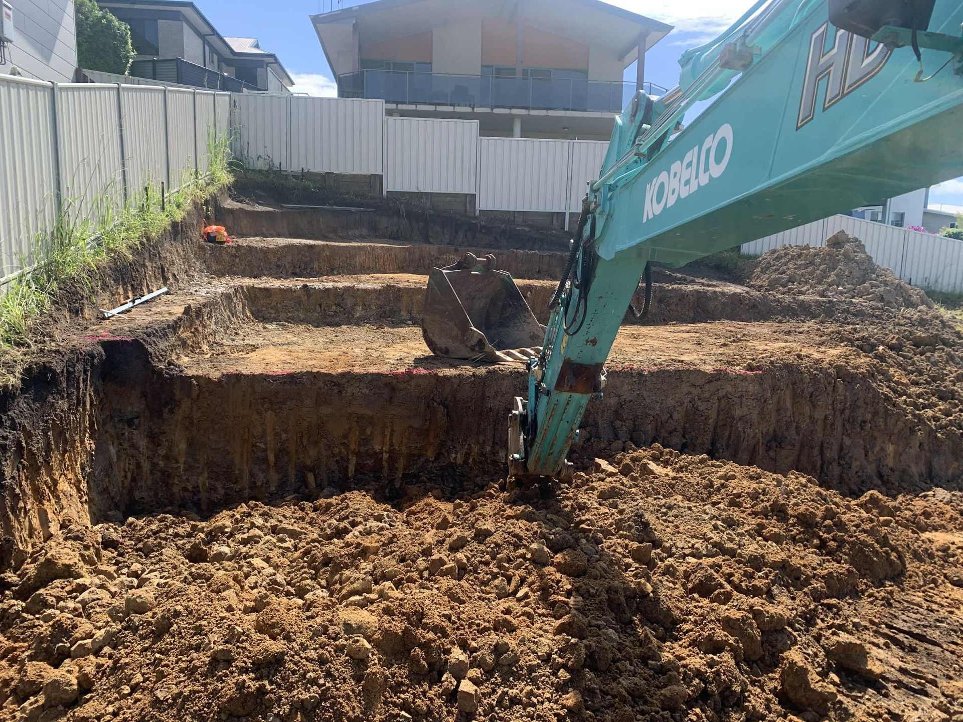 Site cut in hillside with excavator