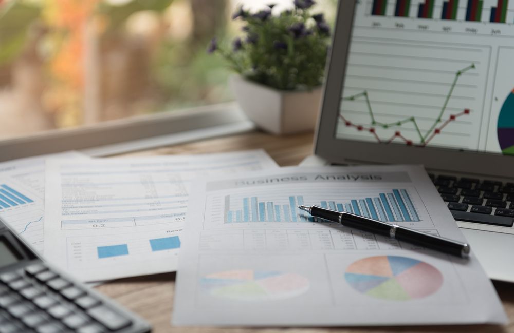 Pen Resting On Business Earning Report And Financial Chart Graph — Blue Chip Bookkeeping In Nome, QLD