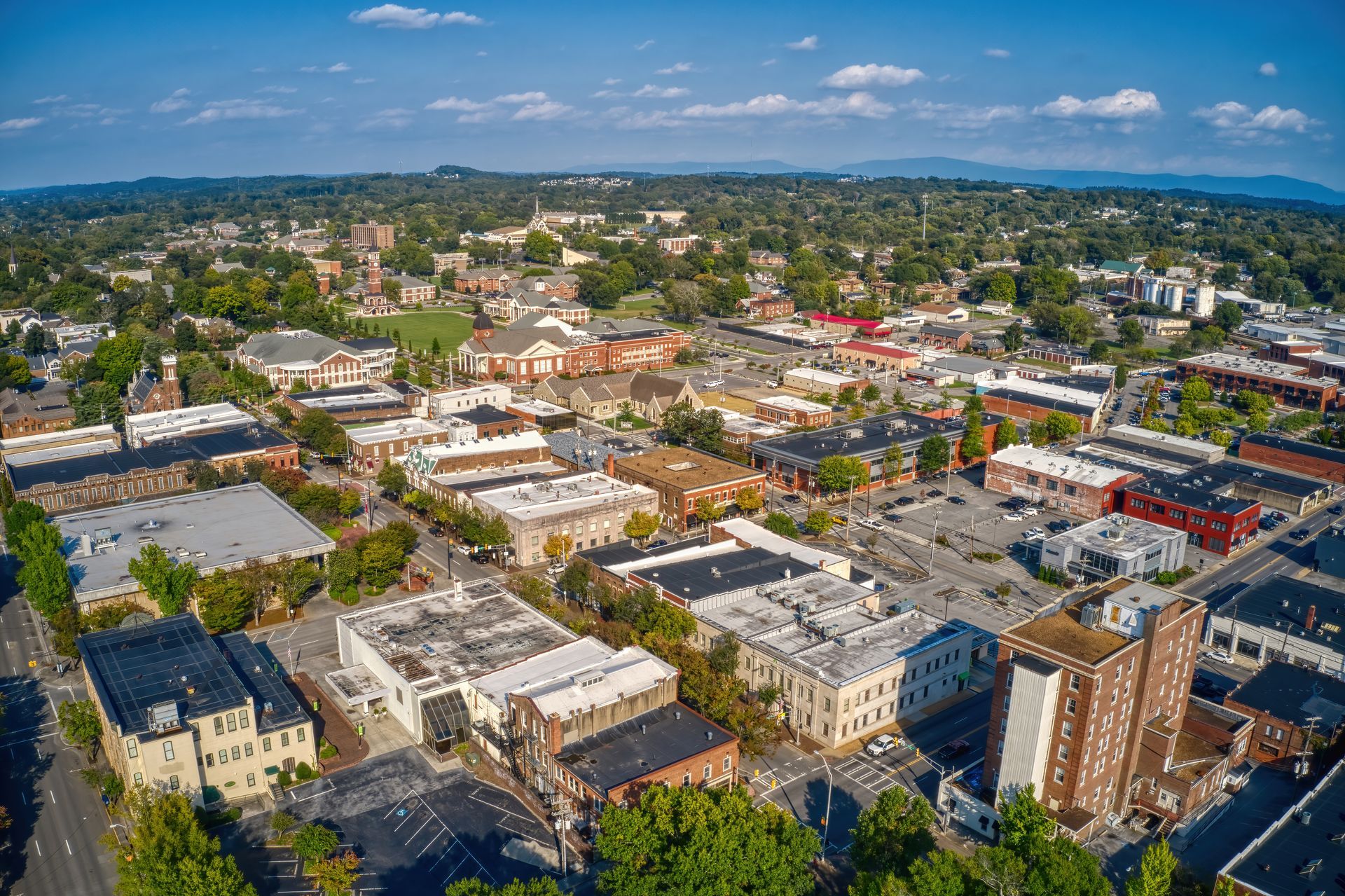 An aerial view of a small town with lots of buildings and trees.