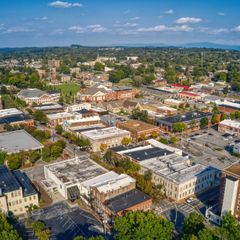An aerial view of a city with lots of buildings and trees