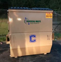 A brown dumpster that says universal waste on it