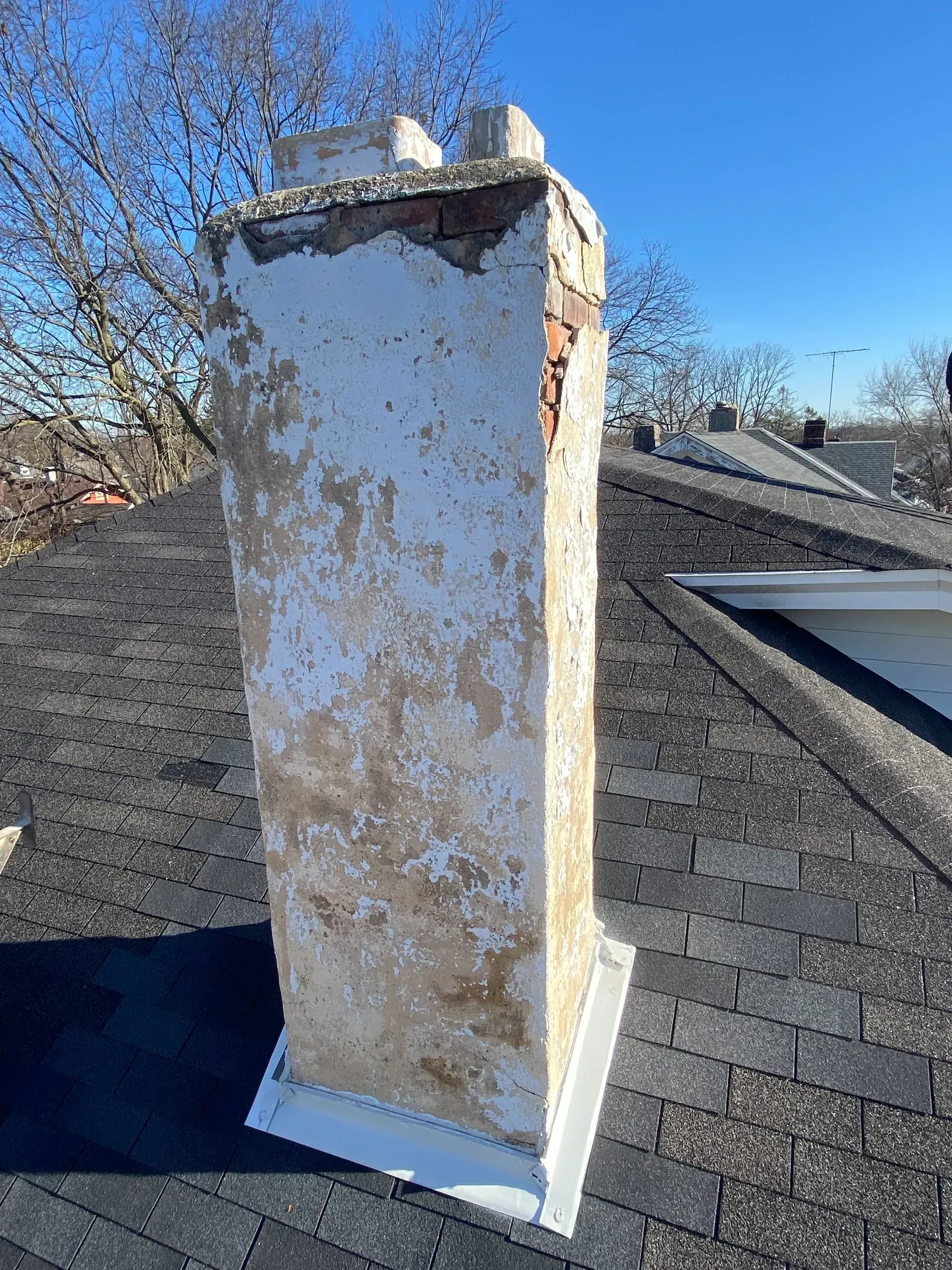 A chimney is sitting on top of a roof.