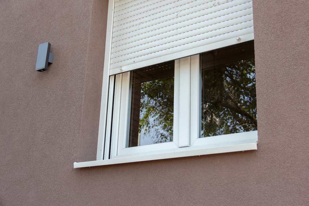 A Window With A Roller Shutter On It Is On The Side Of A Building — Homemakers Lifestyle In Maroochydore, QLD