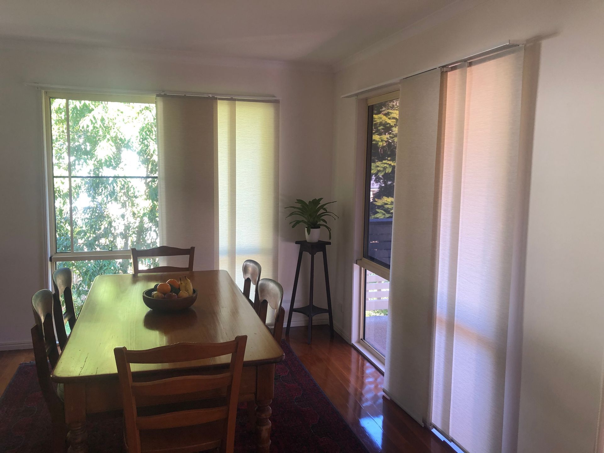 A Dining Room With A Table And Chairs And Sliding Glass Doors — Homemakers Lifestyle In Maroochydore, QLD