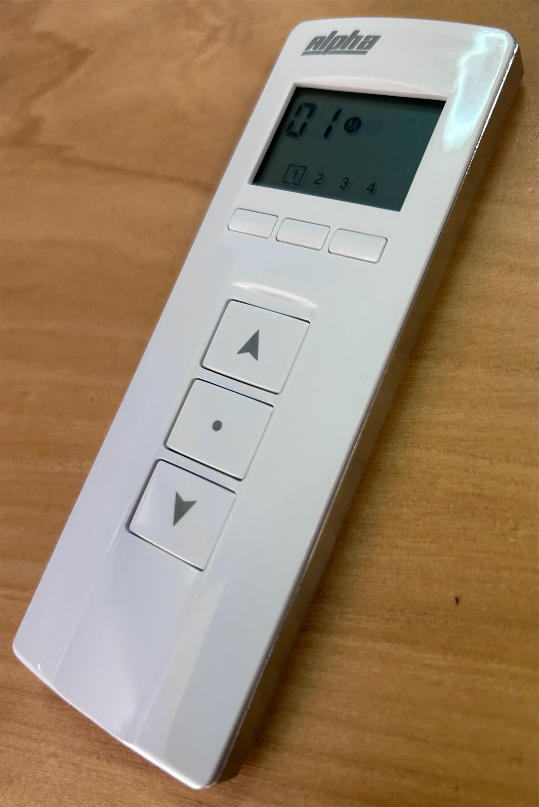 A White Remote Control Is Sitting On A Wooden Table — Homemakers Lifestyle In Maroochydore, QLD