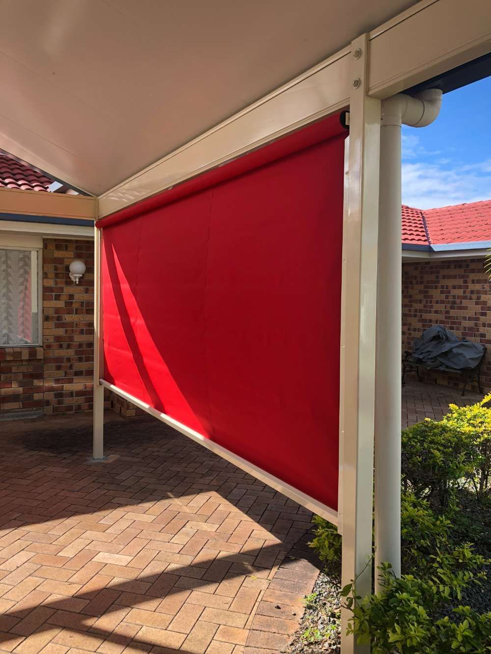 A Red Awning Is Hanging On The Side Of A House — Homemakers Lifestyle In Maroochydore, QLD