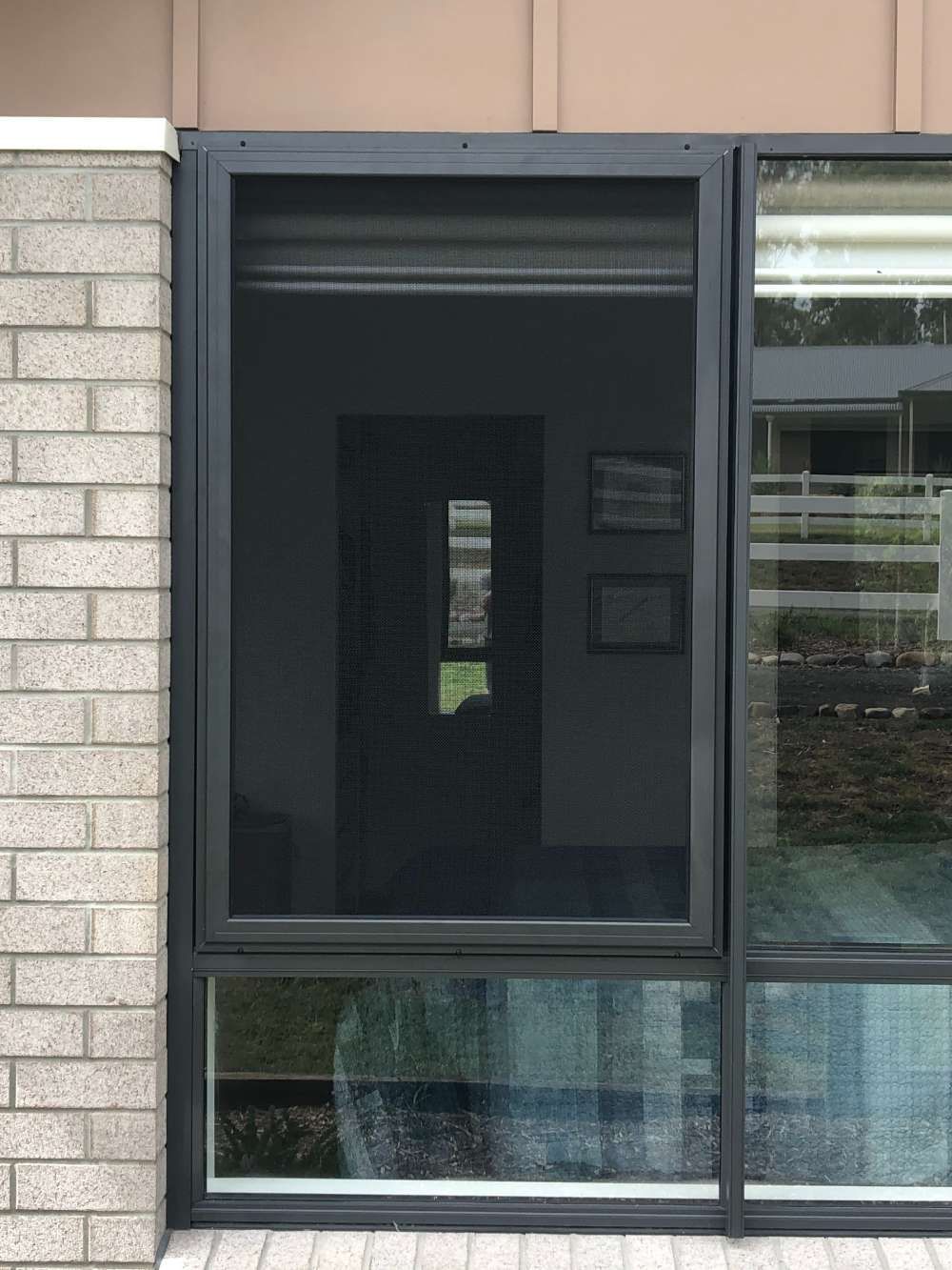 A Window With A Screen On It Is On The Side Of A Building — Homemakers Lifestyle In Maroochydore, QLD