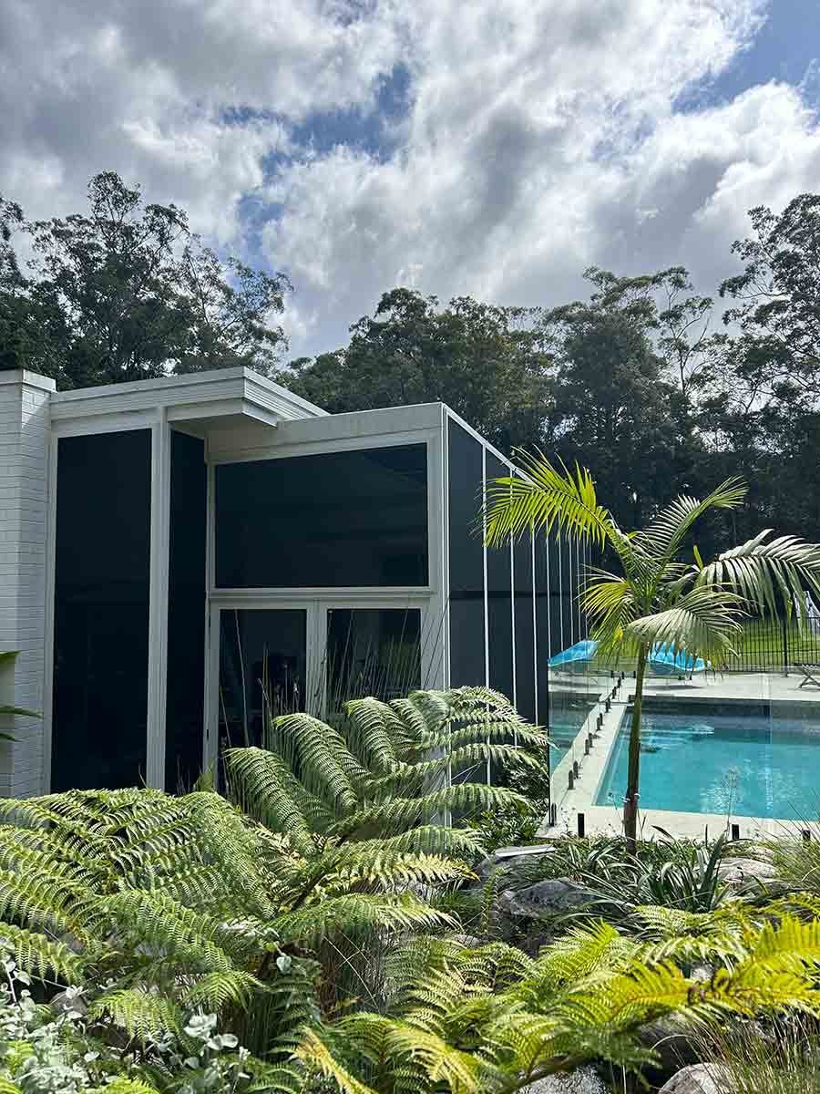 A House With A Swimming Pool And Ferns In Front Of It — Homemakers Lifestyle In Nambour, QLD