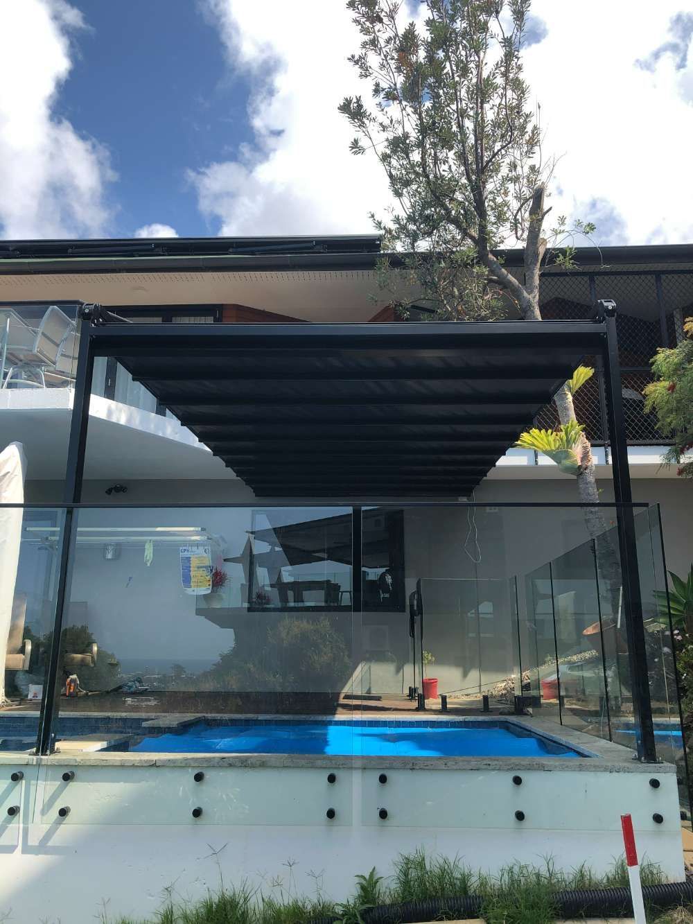 A Black Awning Is Hanging From The Side Of A Building — Homemakers Lifestyle In Maroochydore, QLD