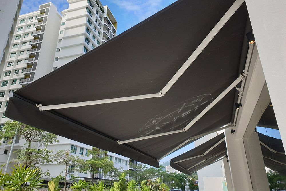 Two grey Folding arm Awning — Homemakers Lifestyle Maroochydore In Maroochydore QLD