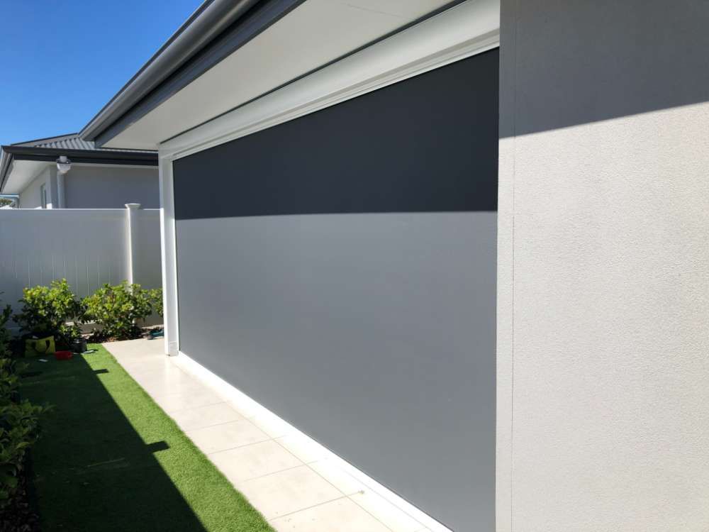 The Side Of A House With A Gray Wall And A White Fence — Homemakers Lifestyle In Maroochydore, QLD