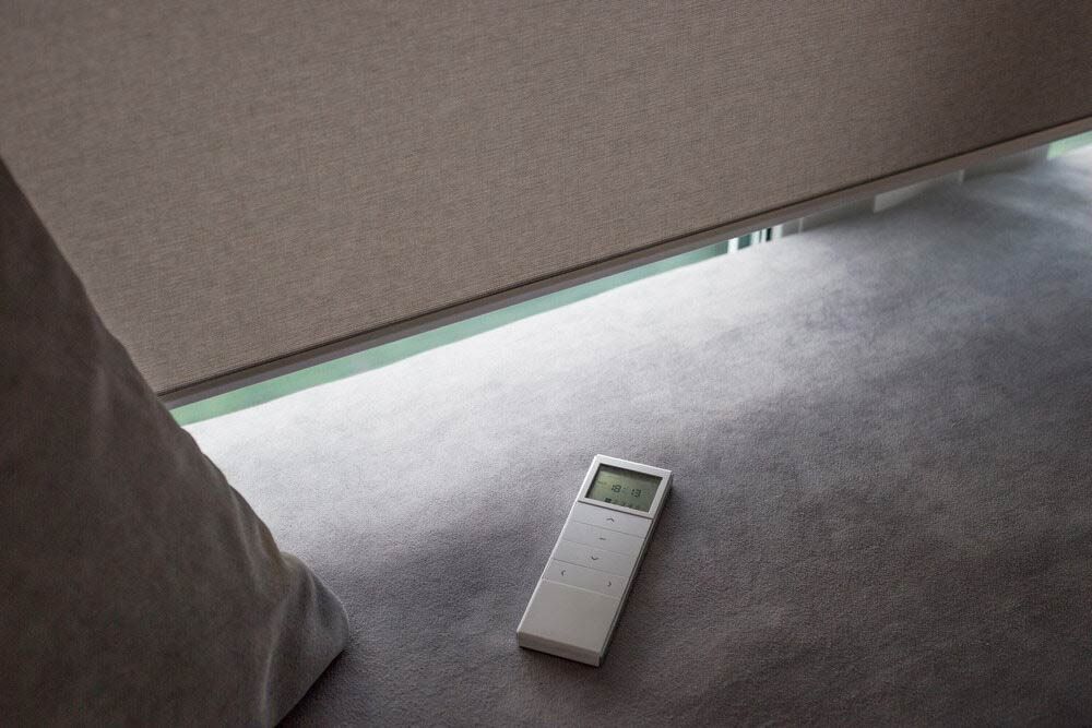 A Remote Control Is Laying On The Floor Next To A Blind — Homemakers Lifestyle In Caloundra, QLD