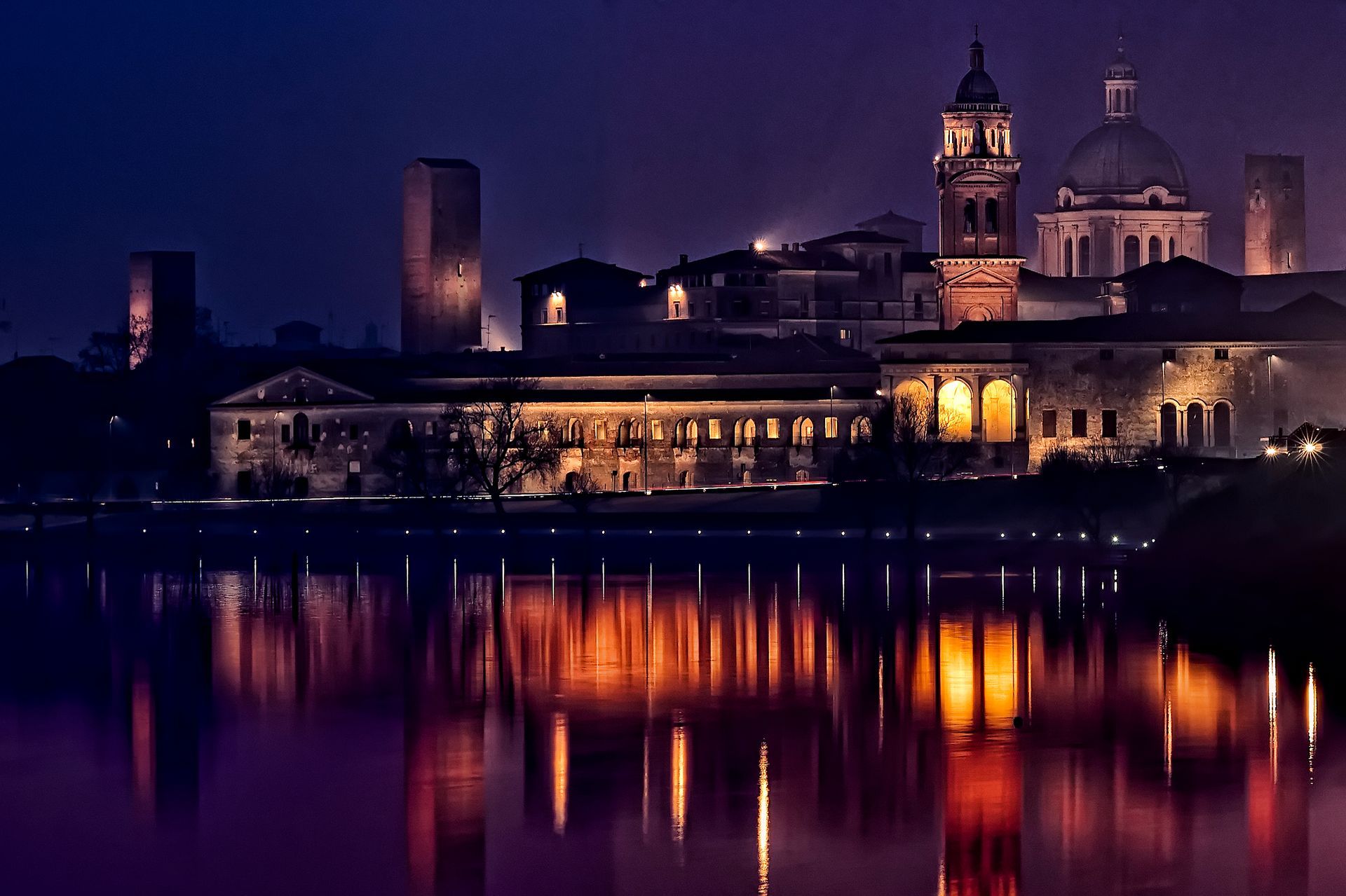 A city at night reflected in a body of water