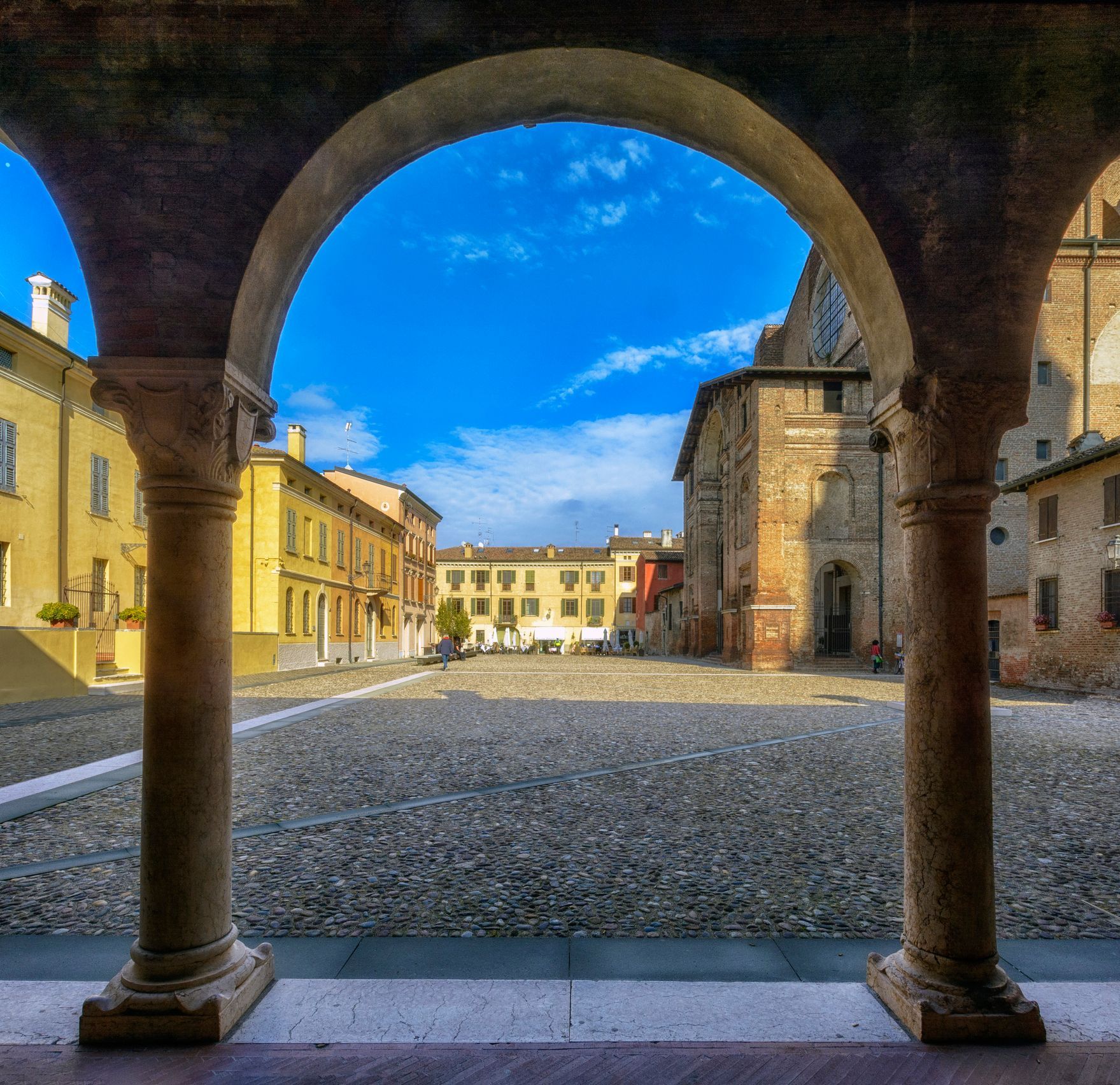 A view of a city through a stone archway