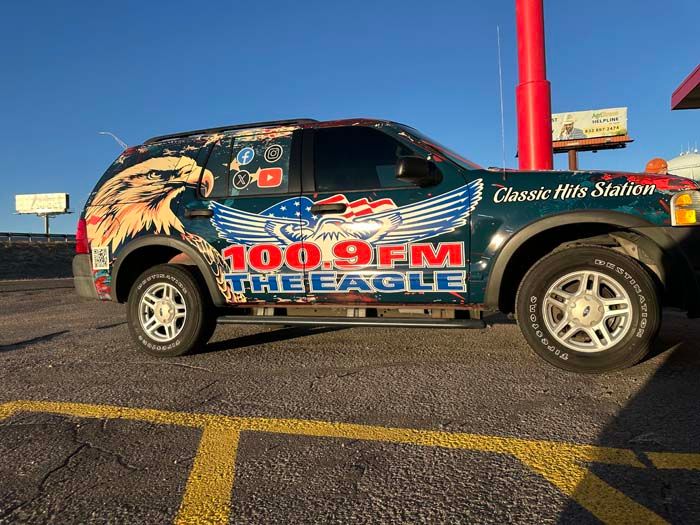 SUV wrapped in patriotic graphics for 100.9 FM The Eagle, a Classic Hits station.