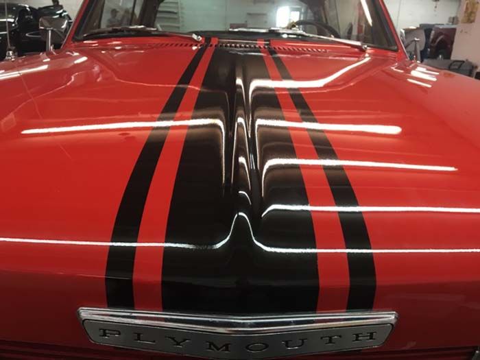 Red Plymouth hood with black racing stripes. 